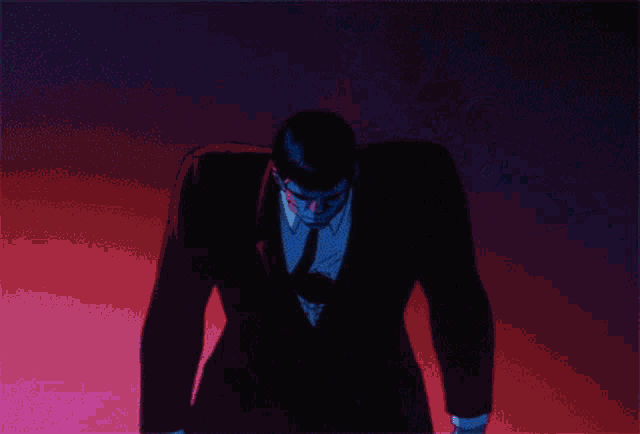 a man is behind a chain link fence in a dark room