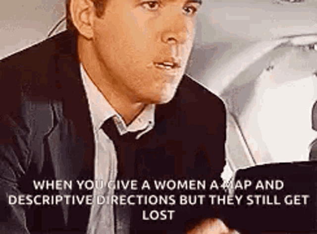 a man in a suit and tie is sitting in a car talking to a woman .