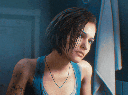 a woman wearing a blue tank top and a necklace looks at herself in the mirror