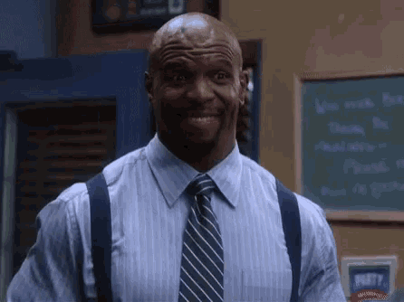a man in a striped shirt and tie is smiling in front of a chalkboard that says party