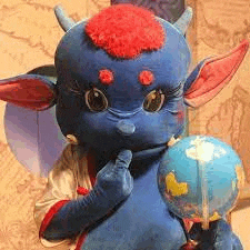 a blue stuffed animal with horns is holding a globe in its hands .