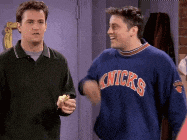 two men are standing next to each other one wearing a new york knicks sweatshirt