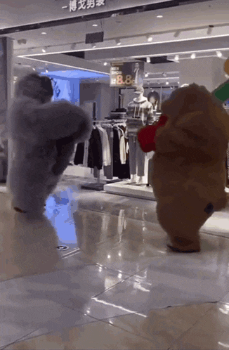 two teddy bears are standing in front of a store with clothes on display