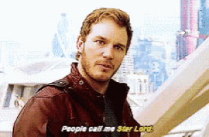 a man in a red jacket is talking to another man and says people call me star lord .
