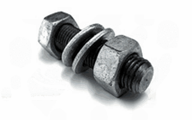 a pile of nuts and bolts on a black surface .