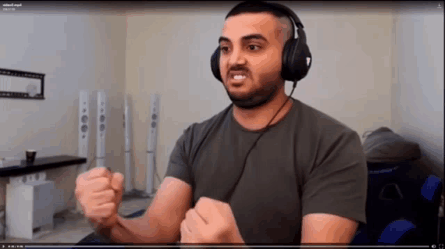 a man wearing headphones is playing a video that says video2.mp4 on the bottom