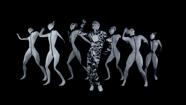 a man in a zebra print suit is surrounded by women in white