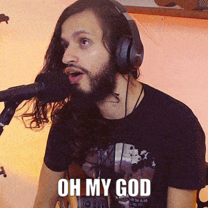 a man wearing headphones is singing into a microphone and the words oh my god are above him