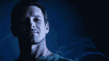 a close up of a man 's face in the dark