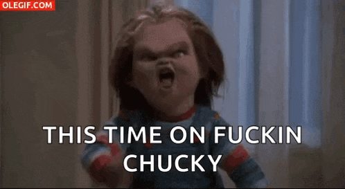 a chucky doll is making a funny face and pointing at the camera .