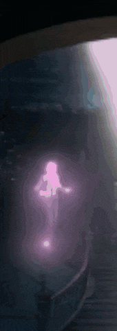 a purple light is shining on a dark surface