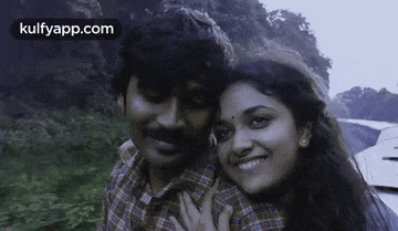 a man and a woman are posing for a picture together and smiling .