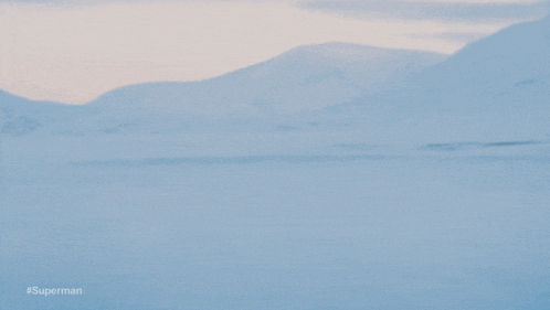 a blurred image of a person running in the snow with #superman written on the bottom