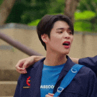 a man wearing a blue t-shirt that says asco is being held by another man .