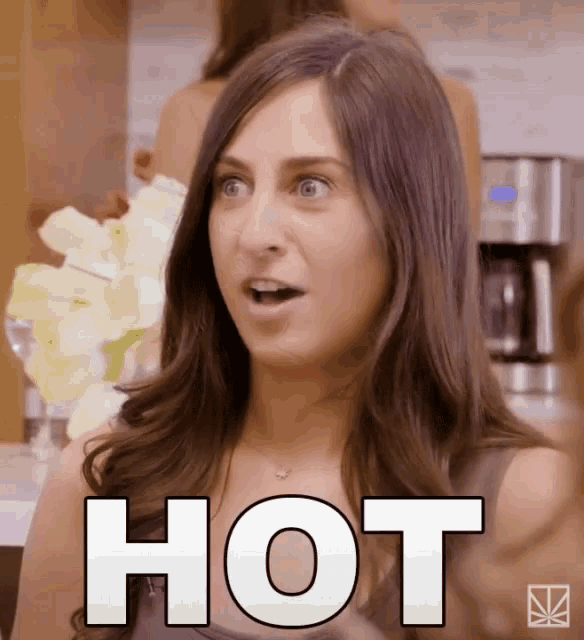 a woman with a surprised look on her face has the word hot written on her chest