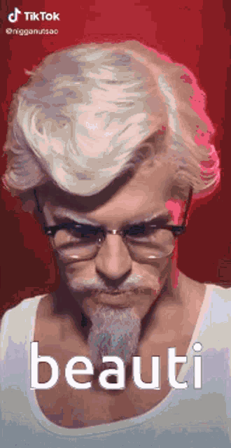 a man with glasses and a beard is wearing a wig and a white shirt .