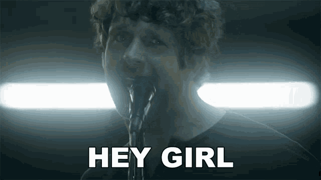 a man singing into a microphone with the words hey girl written below him