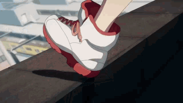 a person wearing a pair of red and white sneakers