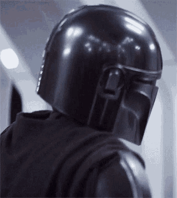 a close up of a person wearing a black helmet and a black hoodie .