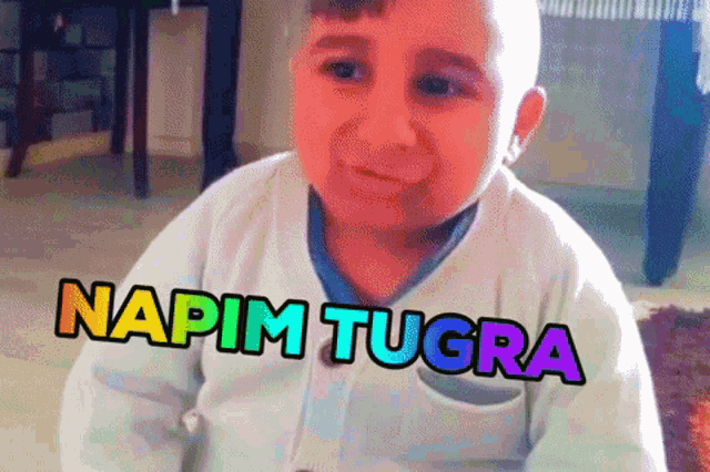 a little boy is making a funny face and the words napim tugra are above him