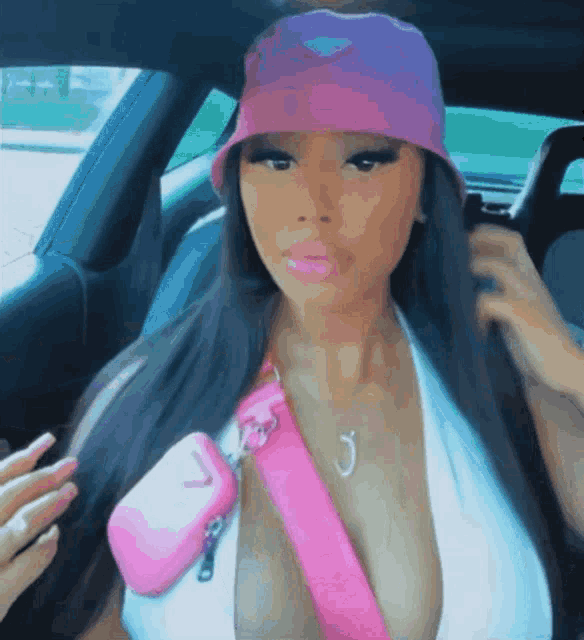 a woman wearing a pink hat and a pink bag