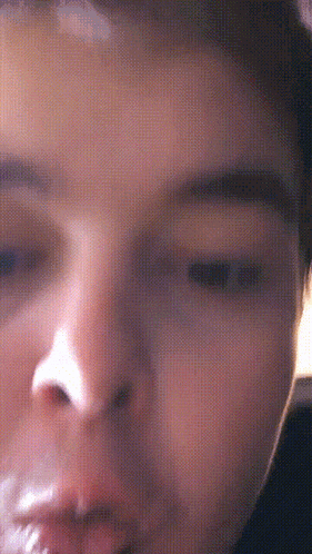 a close up of a person 's face with a white spot on the forehead