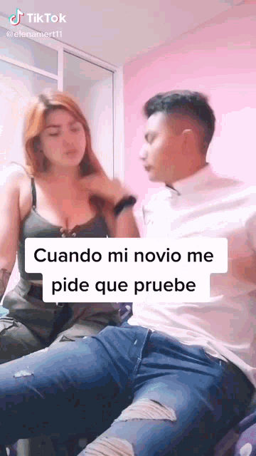 a man and a woman are sitting next to each other and the woman is holding the man 's arm .