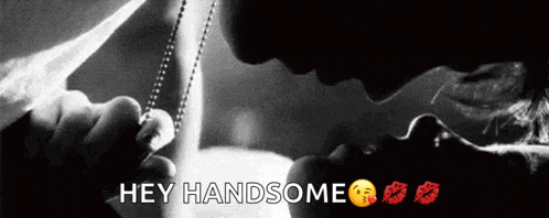 a black and white photo of a man kissing a woman with the words hey handsome below them