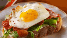 a plate of food with eggs bacon and lettuce on it