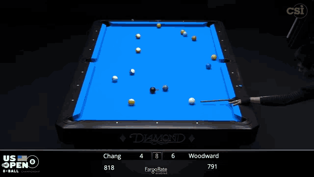 a pool table with a blue cloth and balls on it