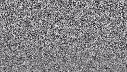 a black and white photo of a gray carpet with a lot of small stones .