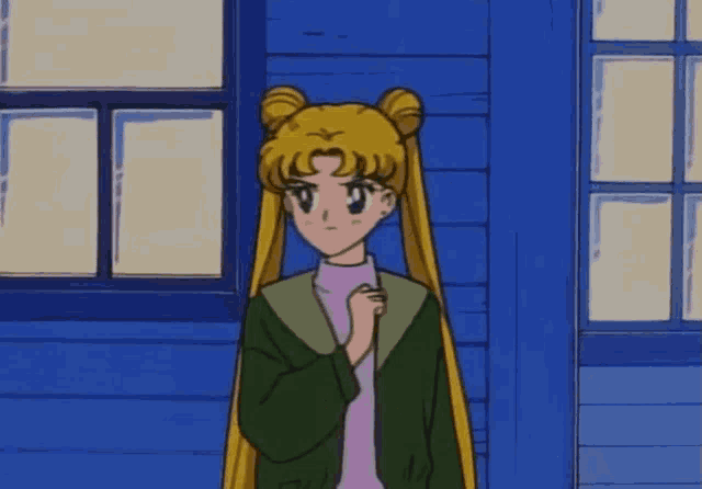 a girl with pigtails is standing in front of a blue wall