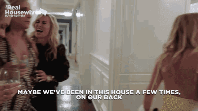a group of women are walking down a hallway with the words maybe we 've been in this house a few times