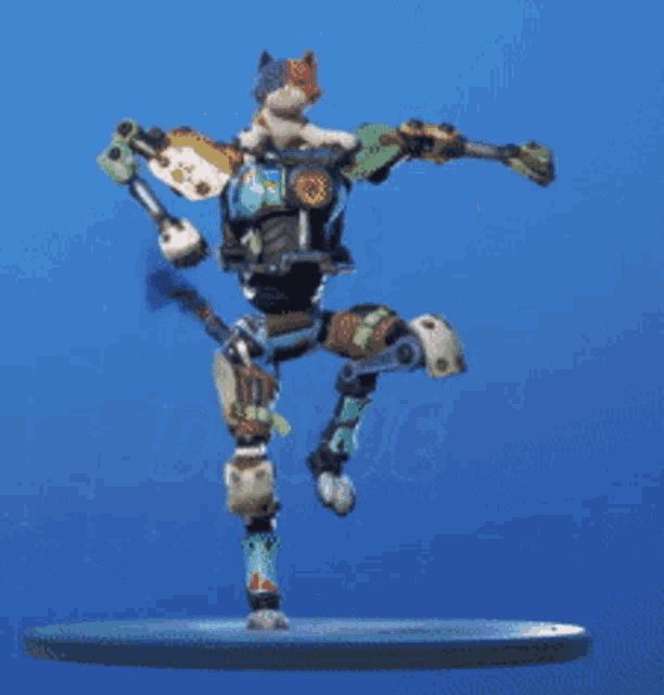 a robot with a cat on it 's head is dancing on a blue background .