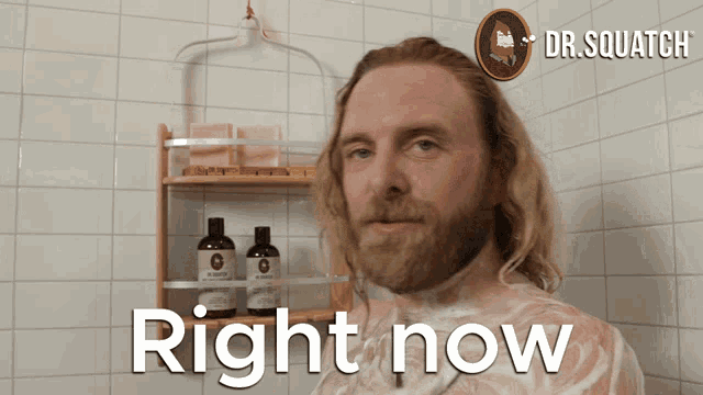 a man with a beard is taking a shower with the words right now below him