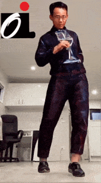 a man is holding a hourglass in front of a i logo