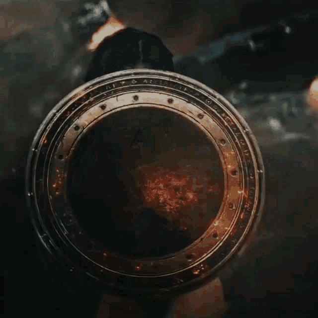 a person is holding a shield that says ' a ' on it