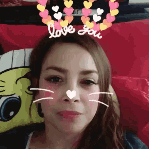 a woman laying on a bed with hearts on her head and the words love you