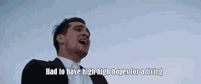 a man in a suit is laughing with the words `` had to have high high hopes for a living ''