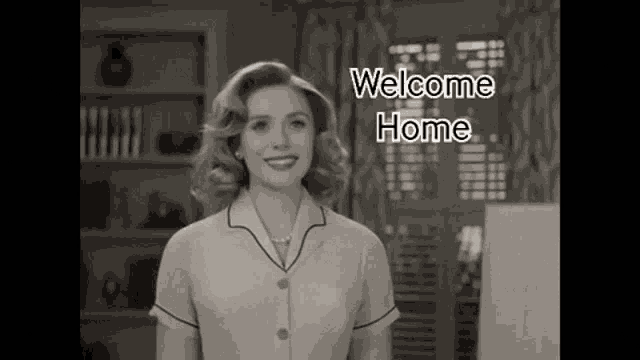 a black and white photo of a woman standing in front of a window with the words `` welcome home '' .