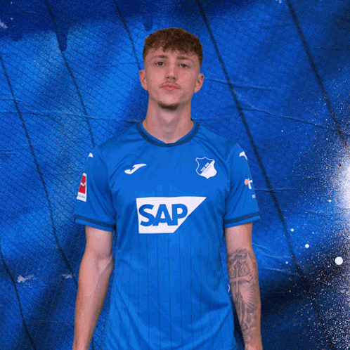 a man wearing a blue shirt with the word sap on the front