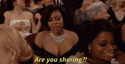 a woman in a black dress is sitting in a crowd of people and saying `` are you sharing ? ''