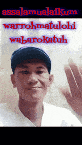 a man in a baseball cap waves his hand in front of a sign that says assalamualaikum