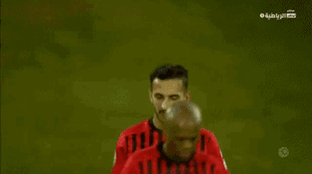 a soccer player in a red jersey with the number 17 on the back