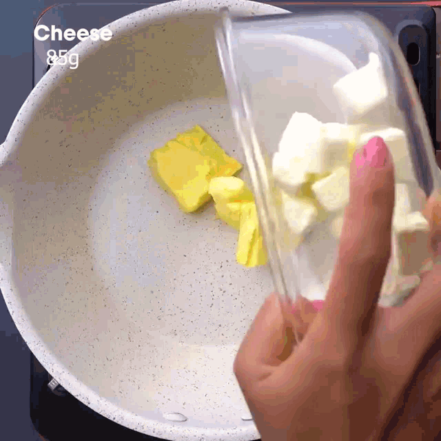 a person is pouring butter into a pot that says cheese 85g on the bottom