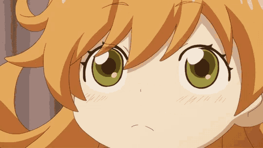a close up of a girl 's face with green eyes and orange hair