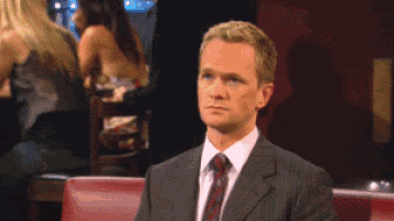 a man in a suit and tie is making a middle finger sign