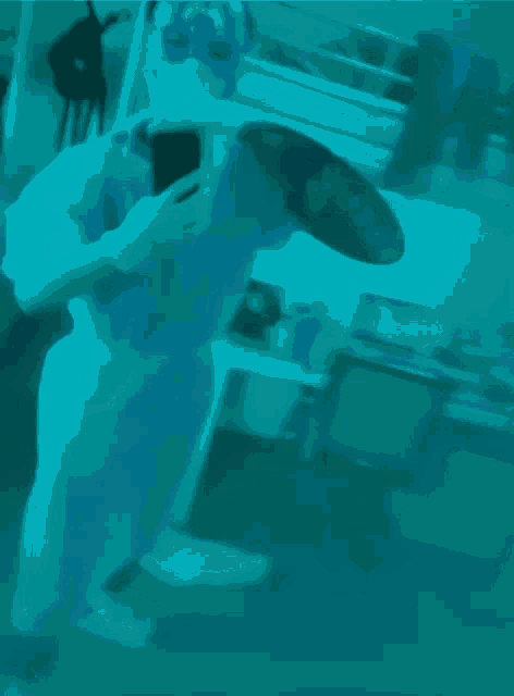 a person in a blue outfit is holding a frisbee and taking a picture of themselves