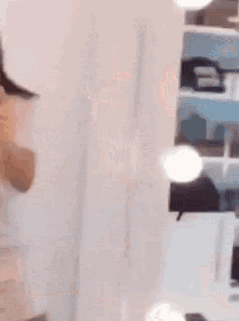 a woman is taking a picture of herself in a mirror while wearing a shirt that says wj