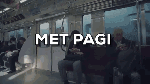a group of people are riding a subway train with the words met pagi written above them .